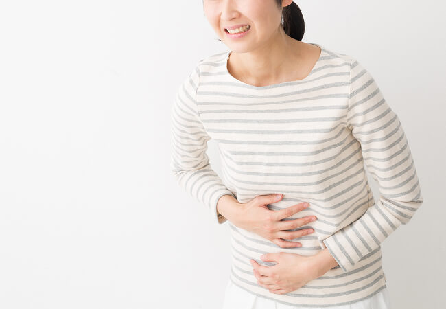 胃を痛めている女性